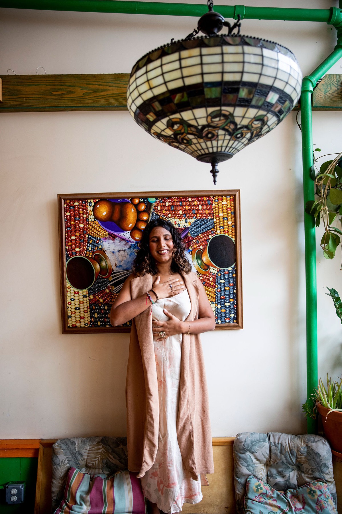 Tanisha standing still with a hand on her heart
