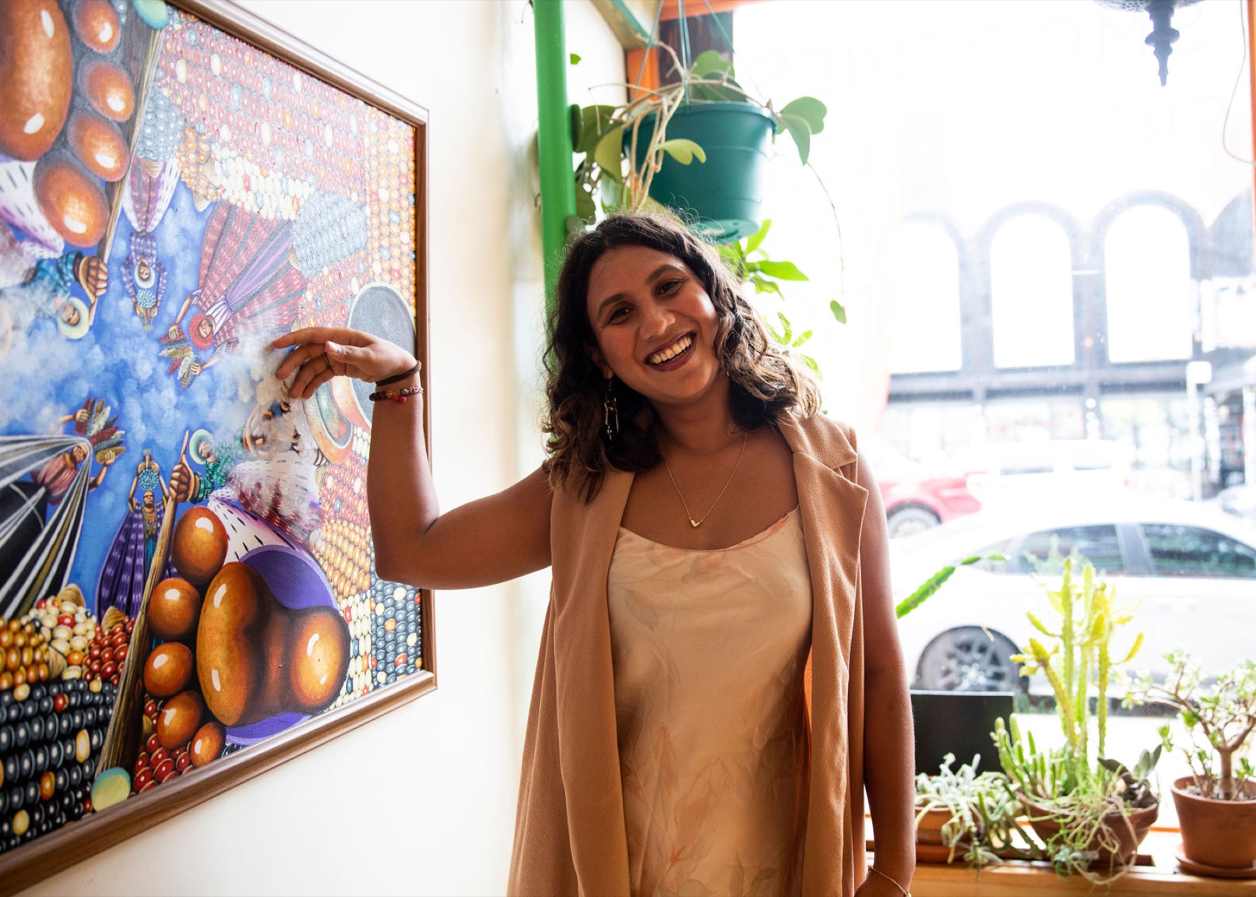 Tanisha mid-gesture, pointing upward, holding the room's attention